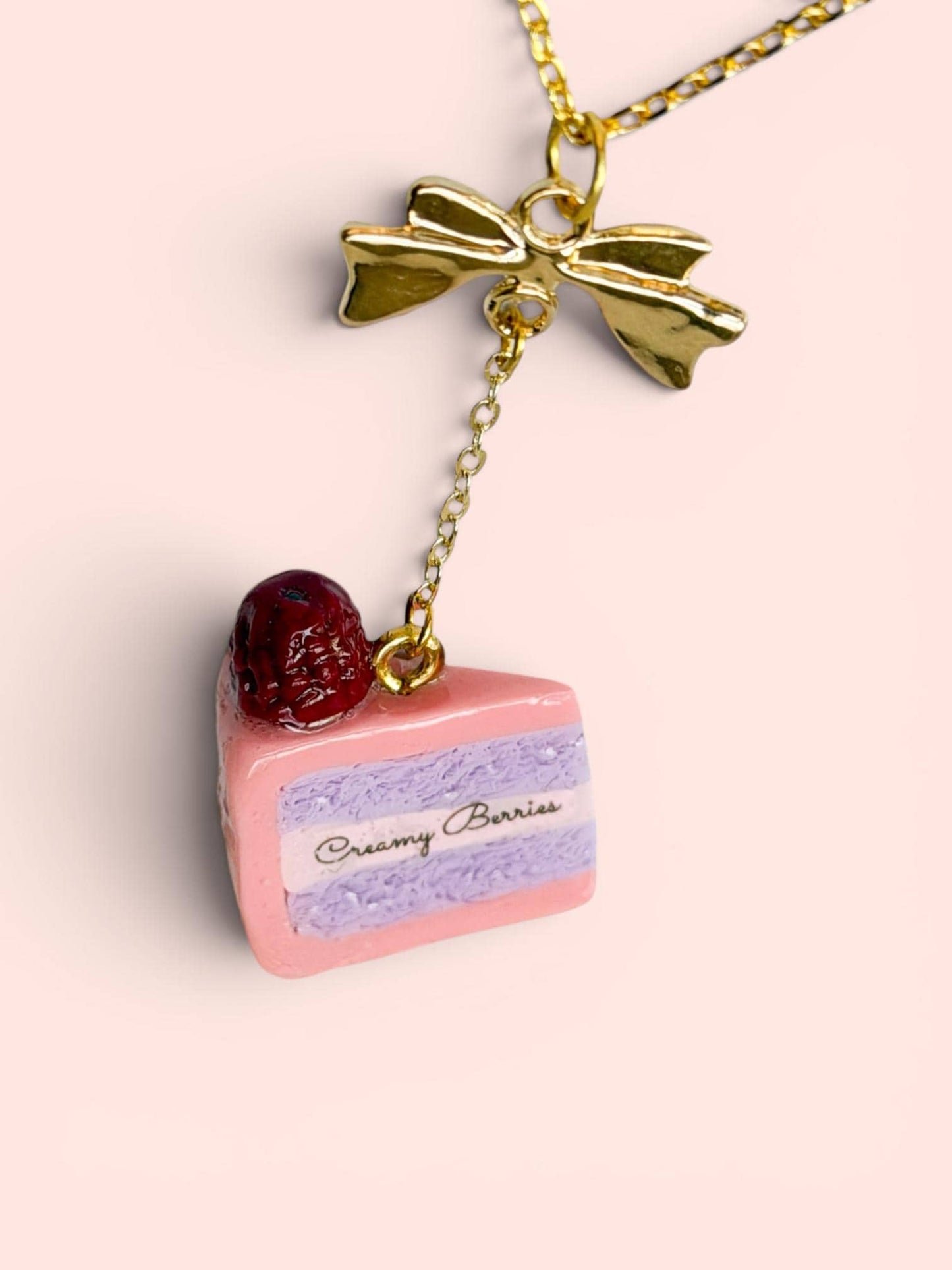 Sliced Cake Necklace with Gold Bow and Creamy Berries Logo
