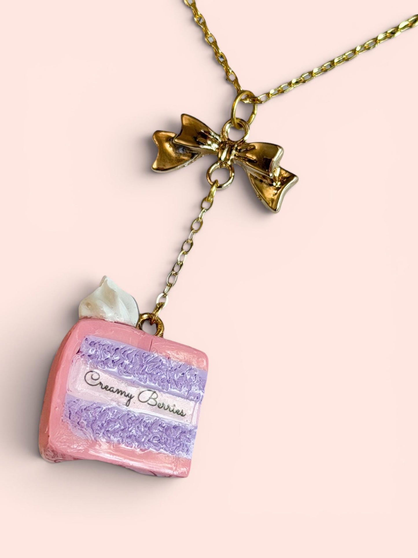 Sliced Cake Necklace with Gold Bow and Creamy Berries Logo